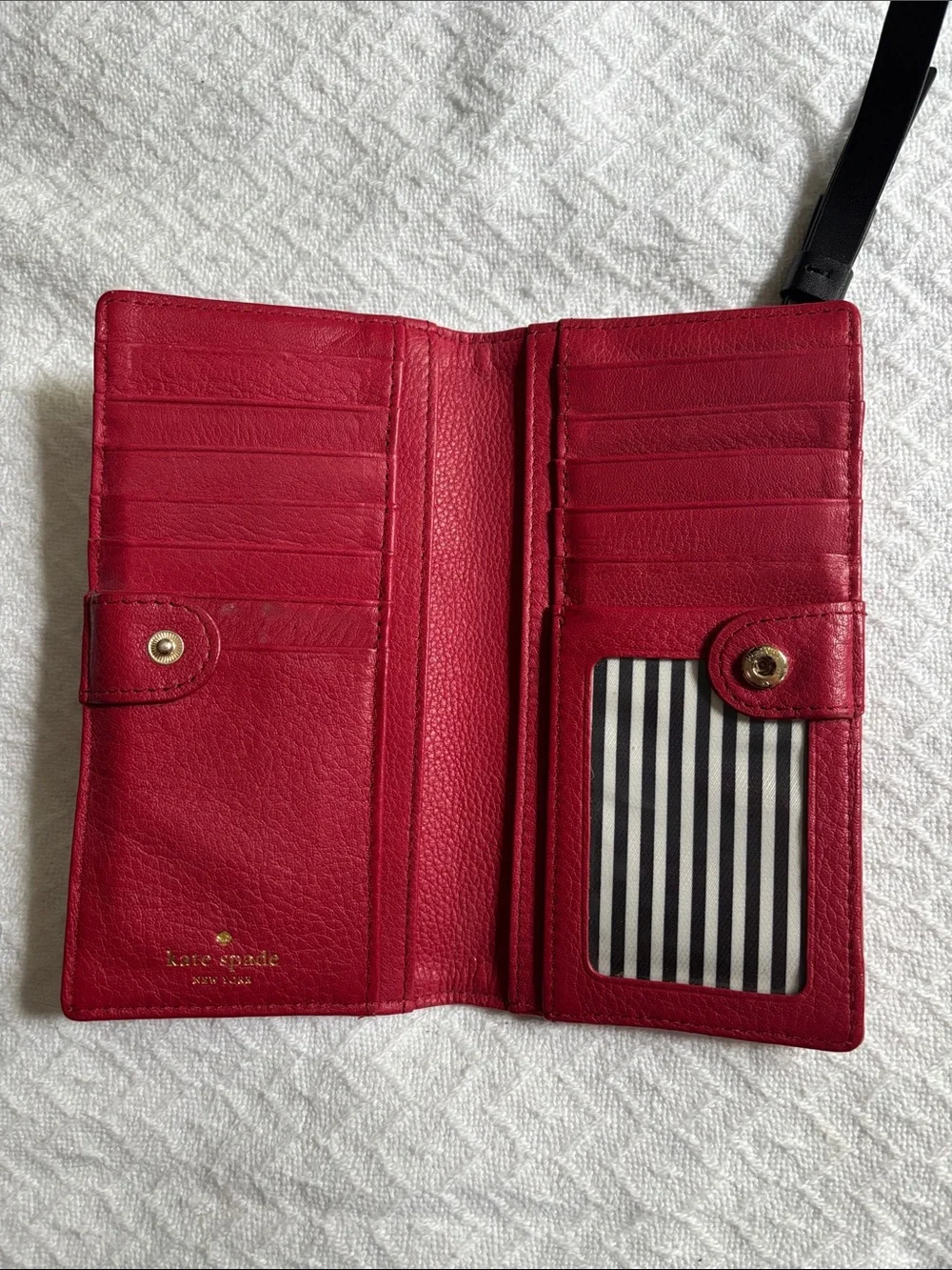 kate spade red pebbled leather zip wristlet with black strap